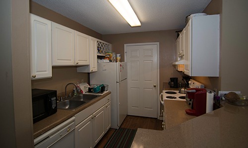kitchen with white cabinets at a sober living home for men