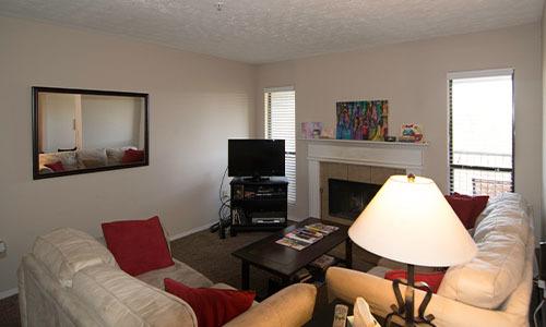 living room with two white couches and a tv