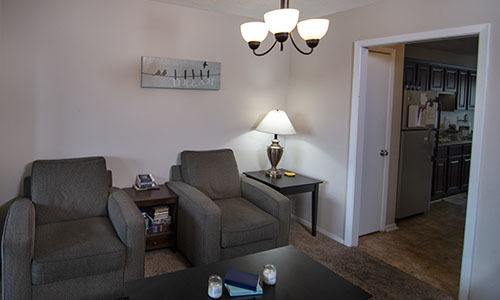 two chairs in the living room of a women's sober living home