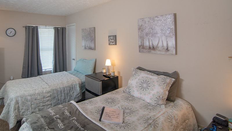 two twin beds in the bedroom of a sober living home in Hoover, AL